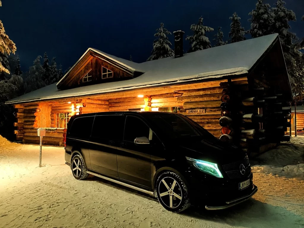 Lapland-Rides Mercedes-Benz minivan outside a snowy Lapland cabin